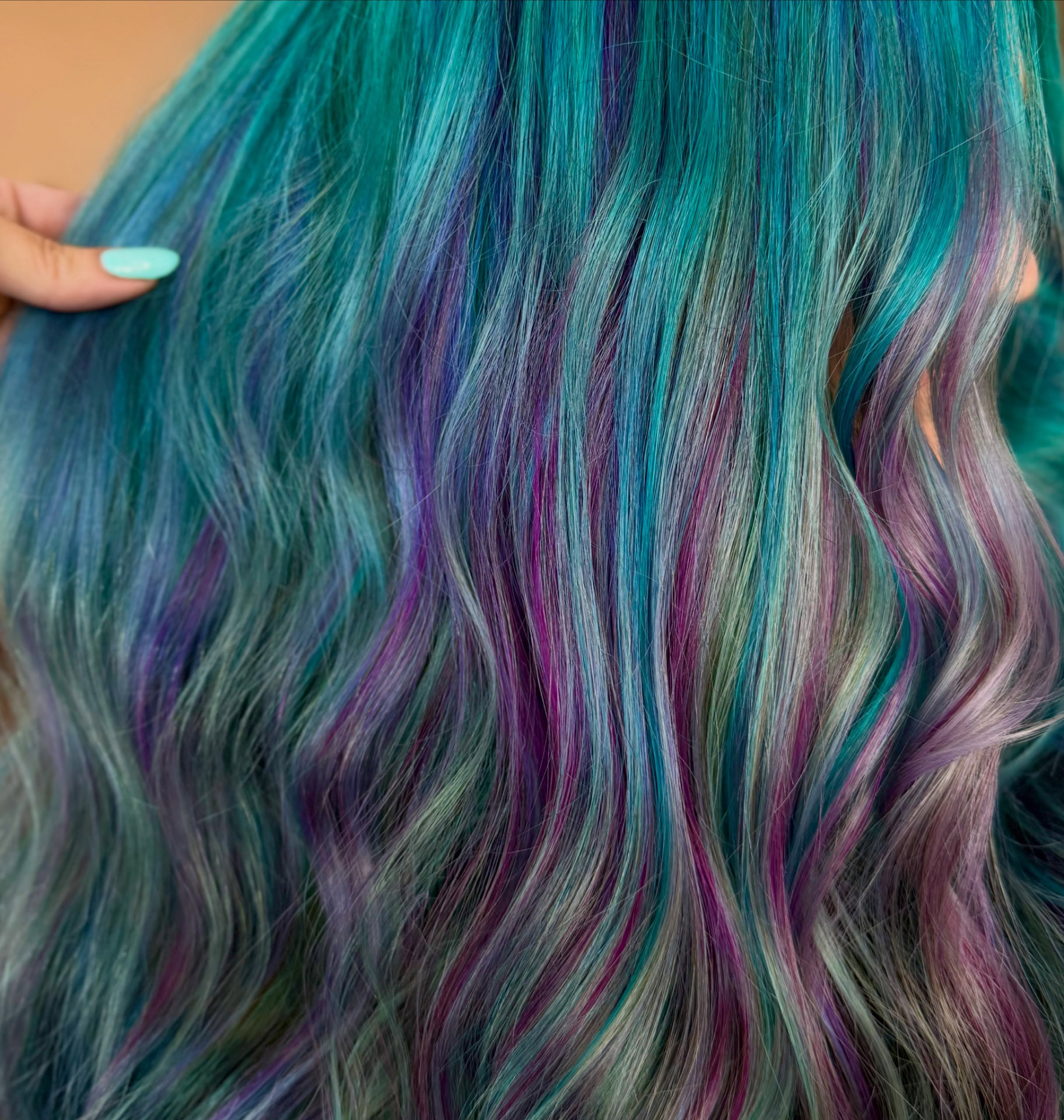 Close-up of teal, violet and silver dimensional hair